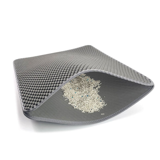 Gray pet mat with a textured top layer and smooth bottom layer on a white background